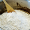 adding powdered sugar to frosting mixture