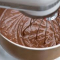 whipping eggs into the melted chocolate mixture