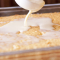 pouring liquid onto gluten free tres leches cake