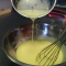 tempering the boiling butter mixture into the egg mixture.